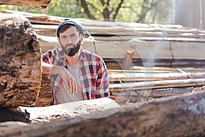 bearded lumberjack in checkered shirt standing photo