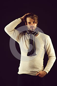 Bearded macho with striped scarf looking confidently