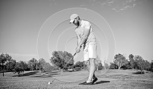 bearded male golf player on professional course with green grass, sport game