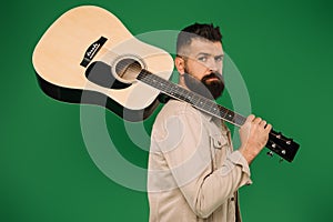 Bearded male guitarist holding acoustic guitar, isolated