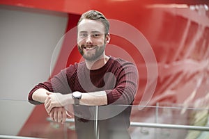 Bearded male student in modern university building, portrait