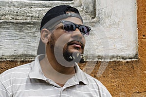 Bearded man 30 to 40 years, with flowers in his beard. Closeup portrait of one handsome smiling man with long black beard showing