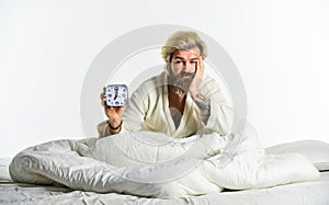 Bearded man with alarm clock. Awakening. Sleep complex biological process that helps process new information, stay