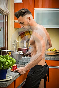 Bearded man in apron preparing breakfast