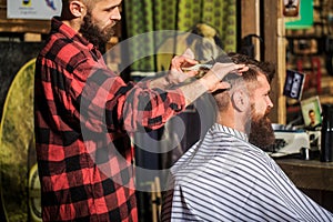 Bearded man in barber shop. Work in the barber shop. Man hairstylist. Hairdresser cutting hair of male client. Man