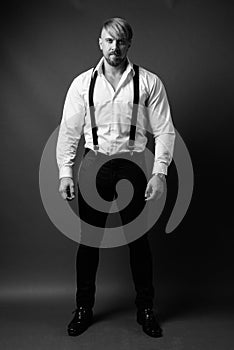 Bearded man with blond hair against gray background