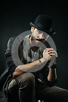 The bearded man in a bowler hat clenched his hands into the lock