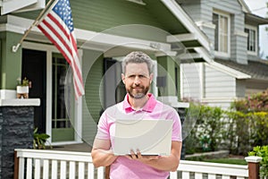 bearded man broker selling or renting house with american flag on pc online, home