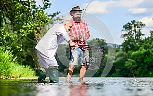 Bearded man and brutal hipster fishing. Family day. Fishing team. Friends catching fish. Hobby and recreation. Catching