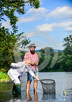 Bearded man and brutal hipster fishing. Fishing team. Friends catching fish. Hobby and recreation. Catching fish with