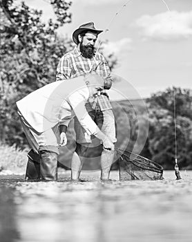 Bearded man and brutal hipster fishing. Fishing team. Friends catching fish. Peace of mind and tranquility. Freshwater