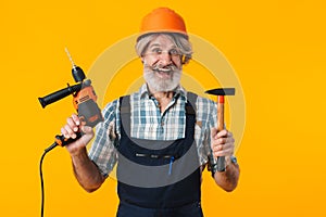 Bearded man builder holding drill