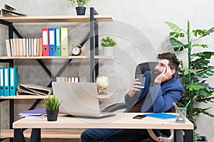 Bearded man in business wear enjoy drinking cup of tea or coffee at office desk, pleasure