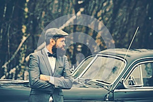 Bearded man in car. Escort man or security guard. Retro collection car and auto repair by mechanic driver. Call boy in