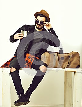 Bearded man, caucasian hipster with moustache holding flask