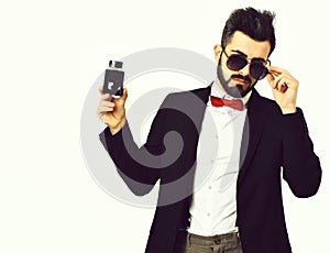 Bearded man, caucasian hipster with moustache, sunglasses and perfume bottle
