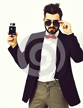 Bearded man, caucasian hipster with moustache, sunglasses and perfume bottle