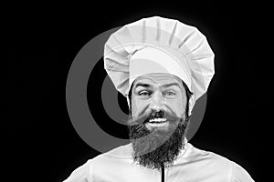 Bearded man in chef uniform. Professional happy man chef. Male chef, cook or baker in white hat and apron. Cooking