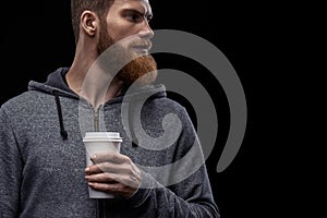 Bearded man with coffee in hand