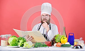 Bearded man cook in kitchen, culinary. Healthy food cooking. Dieting and organic food, vitamin. We detest vegetables