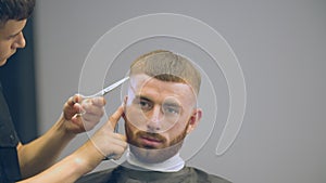 Bearded man cut with scissors