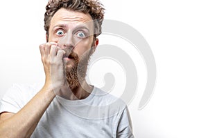 Bearded man in despair with hand near mouth isolated over white background