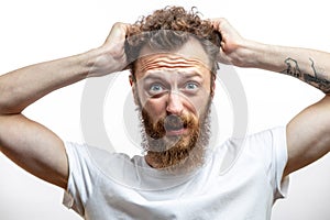 Bearded man in despair with hand near mouth isolated over white background