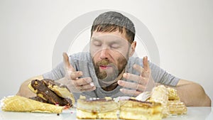 Bearded man devours a cake. harmful but delicious food