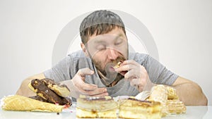 Bearded man devours a cake. harmful but delicious food