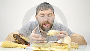 Bearded man devours a cake. harmful but delicious food