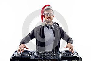 Bearded man dj in christmas hat and plays music on a turntable while isolated on white background