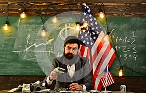 Bearded man with dollar money for bribe. American education reform at school in july 4. Income planning of budget