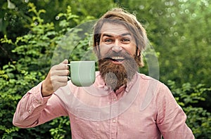 bearded man drinking beverage. mature hipster with beard drink coffee. brutal caucasian hipster hold tea cup. male