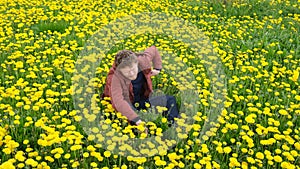 Bearded man in field of yellow dandelions talking on the phone