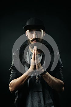 The bearded man in a fitted hat praying