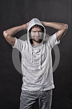 Bearded man frown in hood. Man with beard wear casual sweatshirt. Fashion model in hoodie tshirt. Active lifestyle and
