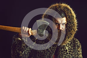 Bearded man in fur with axe
