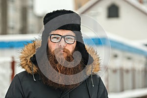 Bearded man in glasses and a black cap in real life.