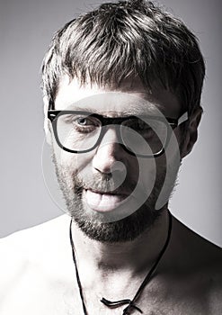 Bearded man in glasses plays the fool. crazy man, funny expression