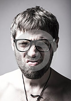 Bearded man in glasses plays the fool. crazy man, funny expression