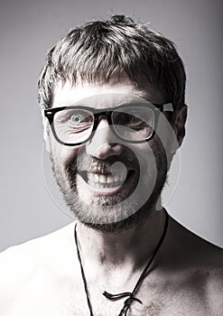 Bearded man in glasses plays the fool. crazy man, funny expression