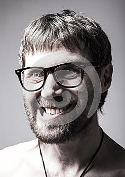 Bearded man in glasses plays the fool. crazy man, funny expression