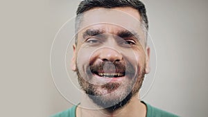 Bearded man in good mood heartily laughing, face close-up, positive emotions