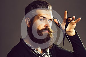 Bearded man with hairdresser scissors