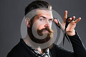 Bearded man with hairdresser scissors