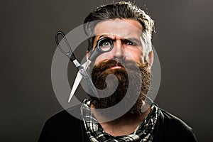 Bearded man with hairdresser scissors