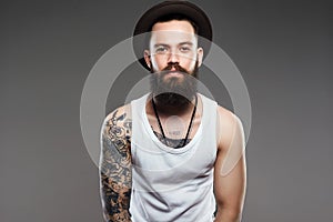 Bearded Man in Hat. hipster boy with tattoo