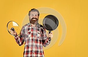 bearded man hold kitchen pan. brutal hipster cooking with saucepan. housekeep husband cook in pot. mature chef in