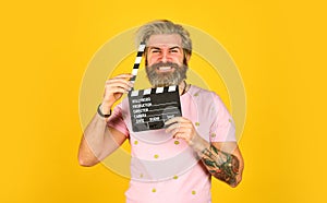 Bearded man hold movie clapper. Film making concept. Clapperboard copy space. Watch movie. Film director. Actor casting