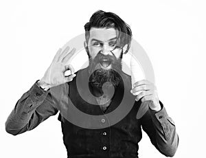 Bearded man holding bottle of kefir with happy face